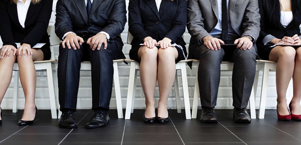 Five applicants sitting and waiting for a job interview